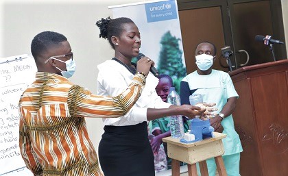 A journalist demonstrating how to properly wash hands during the workshop in Accra. Picture: SAMUEL TEI ADANO